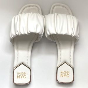 White sandals with gold accents by NYC Madison